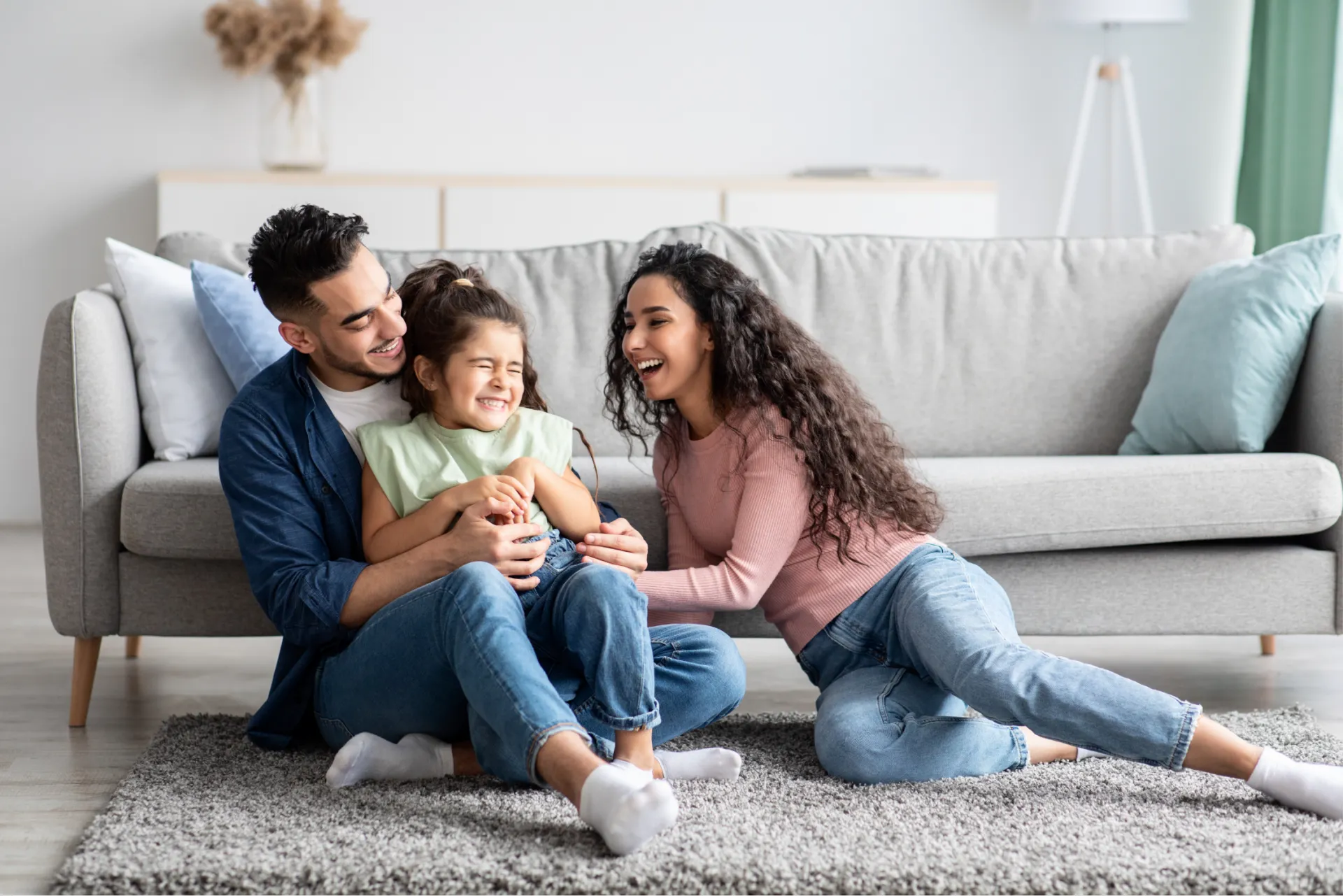 Happy family with their child sitting together and smiling