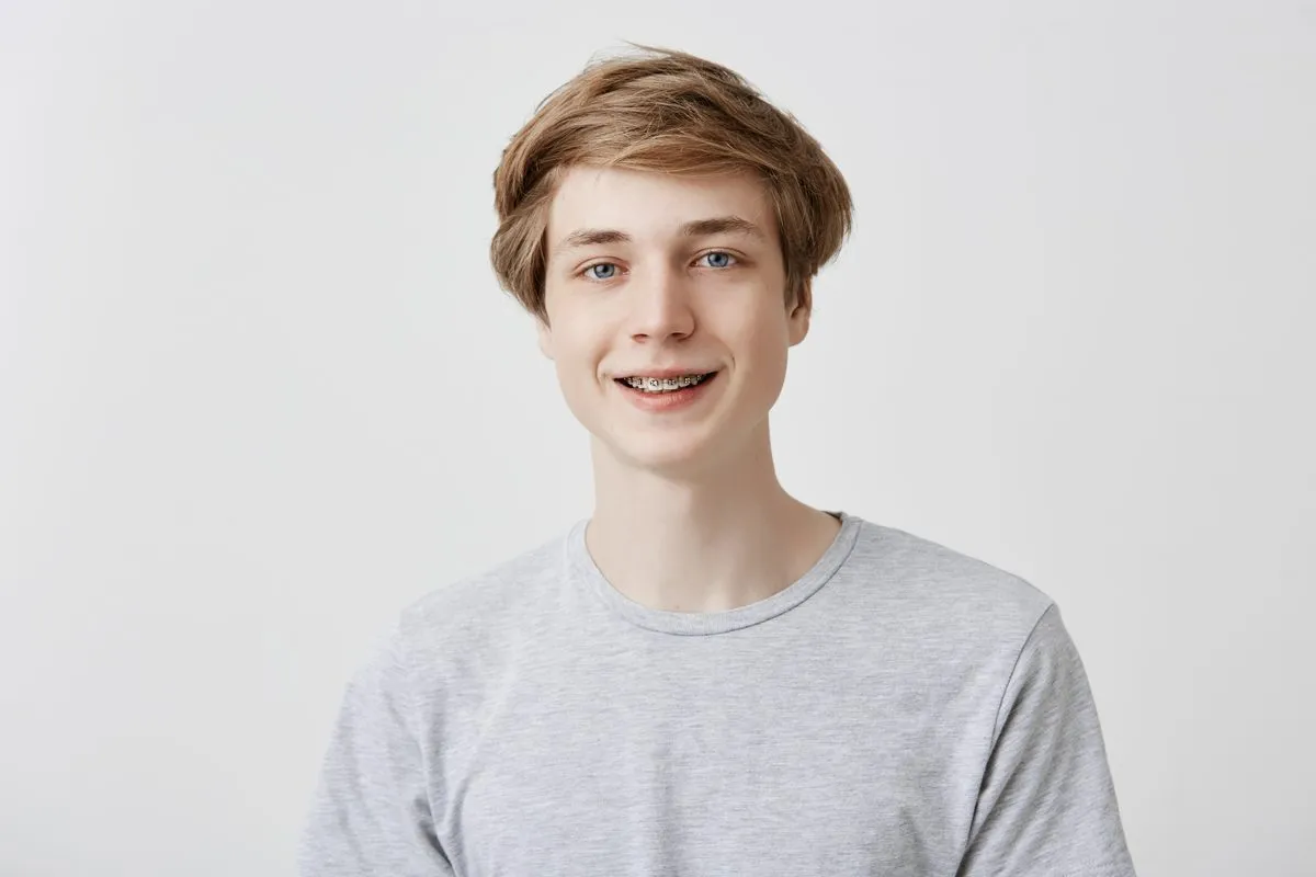 Teenager with braces smiling confidently